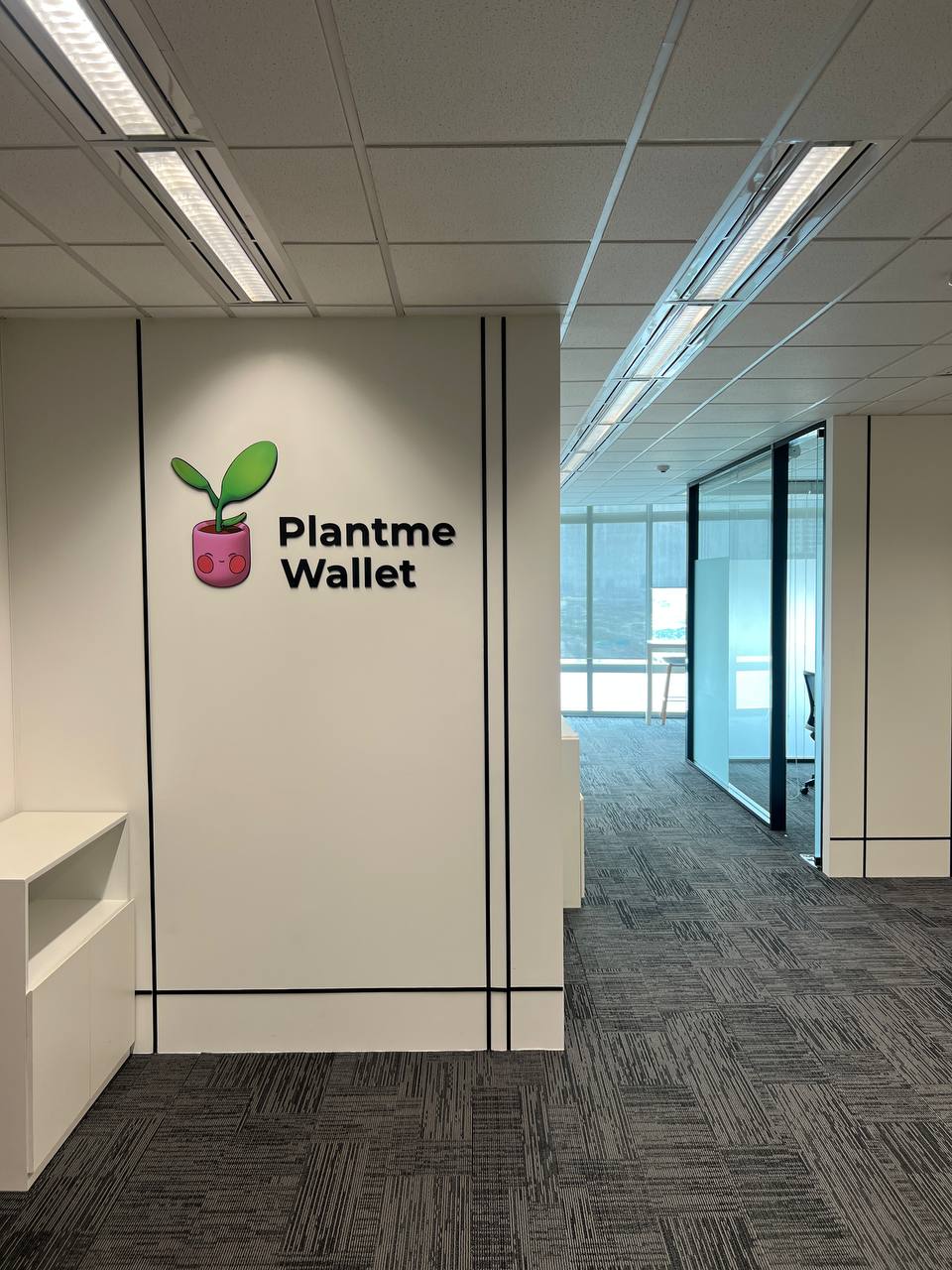 PlantMe Wallet wall logo at the Thailand office